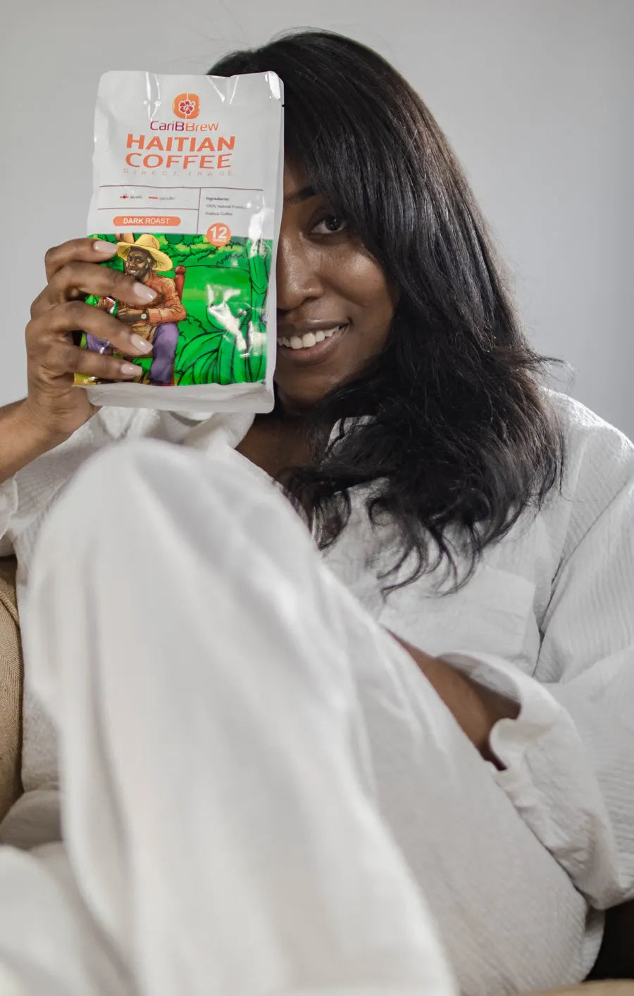 Woman holding up a bag of Haitian Coffee